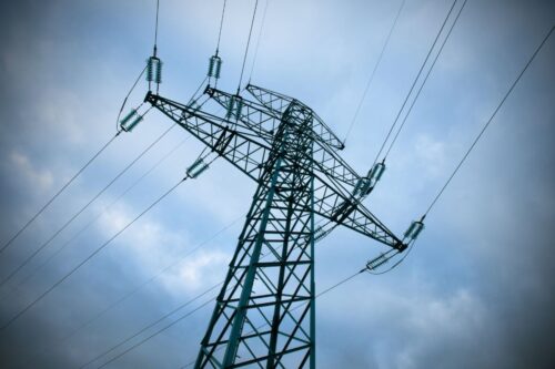 Power lines against a cloudy blue sky